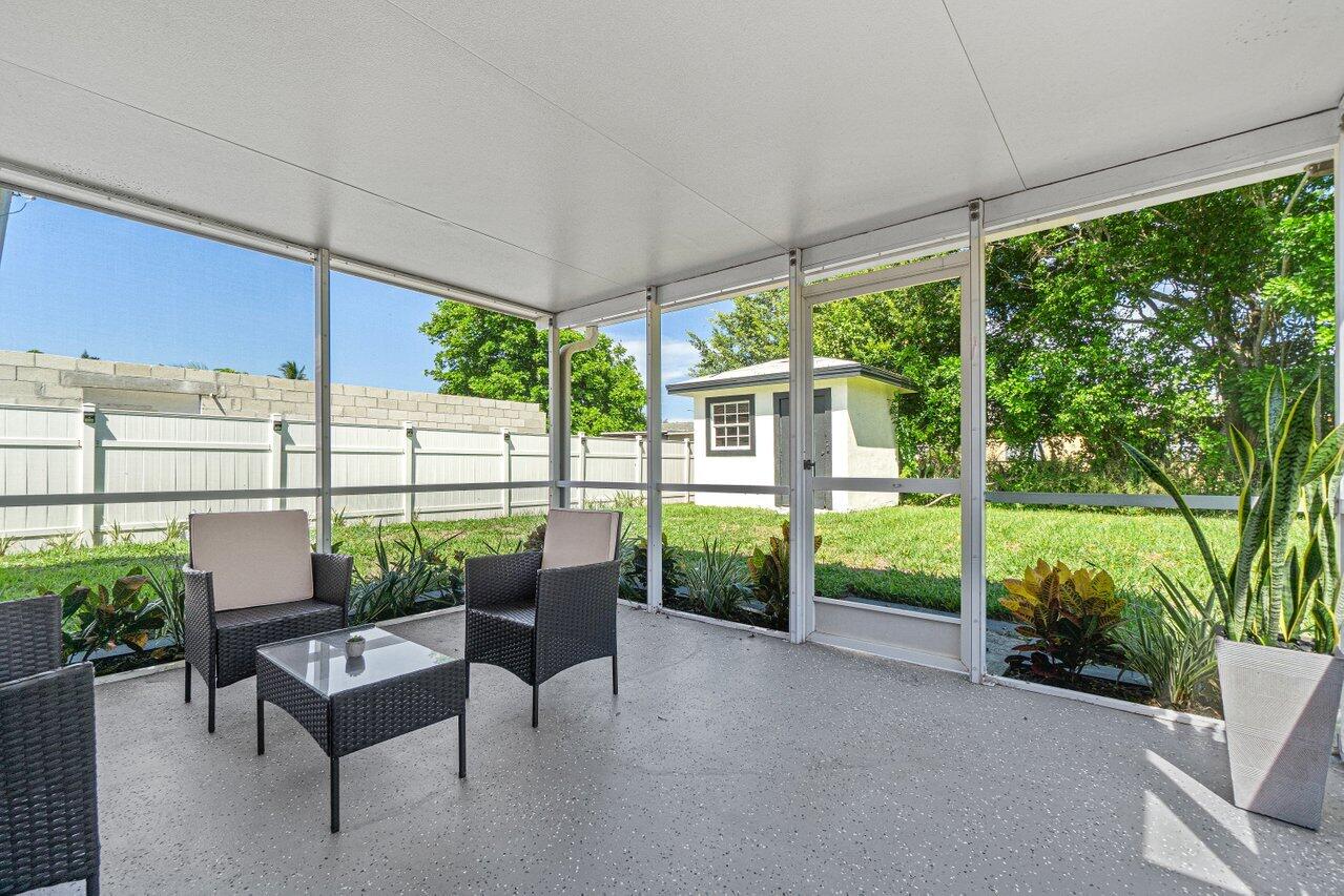 1250 Southwest 6th Avenue Deerfield Beach, FL 33441 - Photo 18 of 22 a balcony with furniture and garden view
