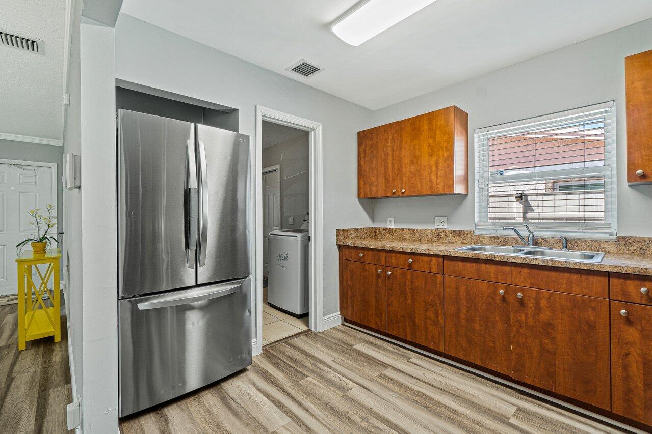 1250 Southwest 6th Avenue Deerfield Beach, FL 33441 - Photo 10 of 22 a kitchen with stainless steel appliances granite countertop a refrigerator and a sink