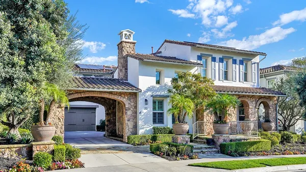 a front view of a house with yard and green space
