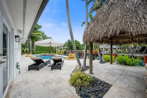 a view of a patio with table and chairs potted plants