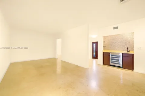 an empty room with wooden floor and a large window