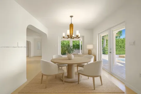 a dining room with furniture a window and wooden floor