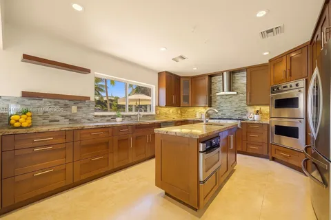 a kitchen with stainless steel appliances granite countertop a stove and a sink