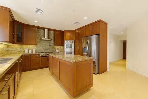 a kitchen with stainless steel appliances granite countertop a refrigerator and a stove