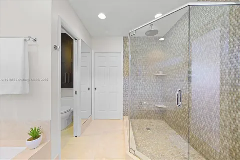 a bathroom with a shower and a tub