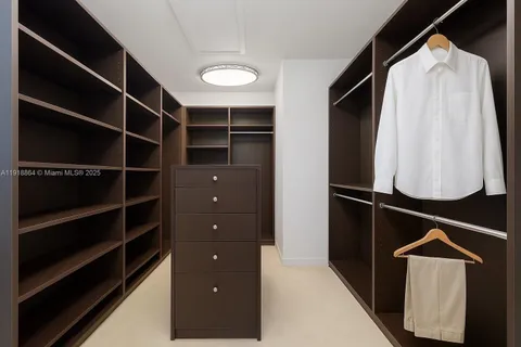 a view of walk in closet with empty racks
