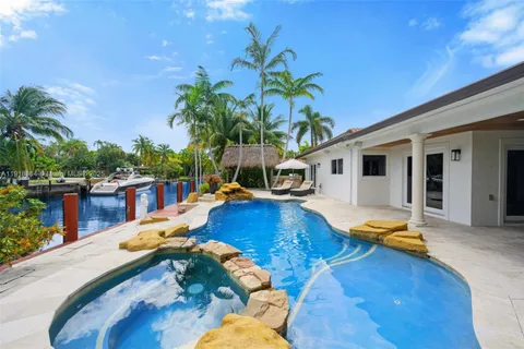 a swimming pool with outdoor seating