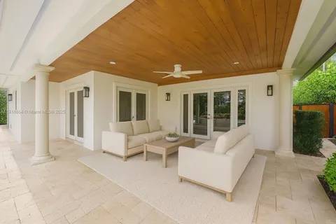 a balcony with furniture and large windows