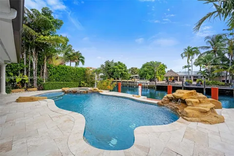 a view of a swimming pool with a patio and a yard