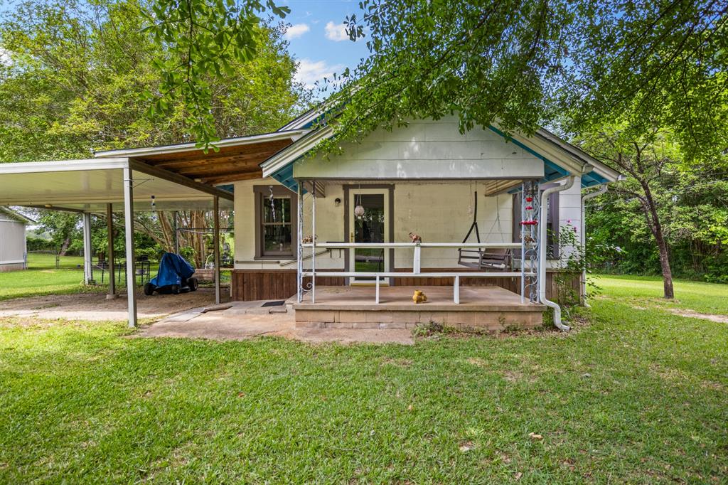 103 South Sun Camp Road White Oak, TX 75693 - Photo 2 of 40 a view of a house with a yard porch and sitting area