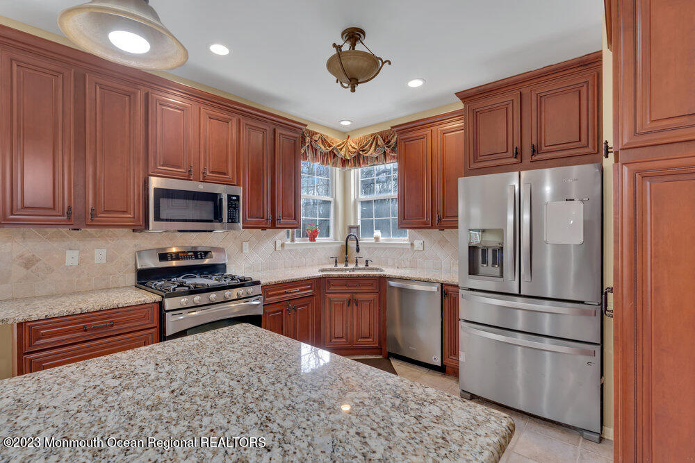 4 Blacksmith Pass Colts Neck, NJ 07722 - Photo 11 of 38 a kitchen with stainless steel appliances granite countertop a refrigerator stove microwave and sink