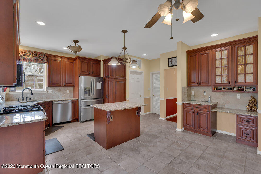 4 Blacksmith Pass Colts Neck, NJ 07722 - Photo 12 of 38 a large kitchen with a large counter top cabinets appliances and a ceiling fan
