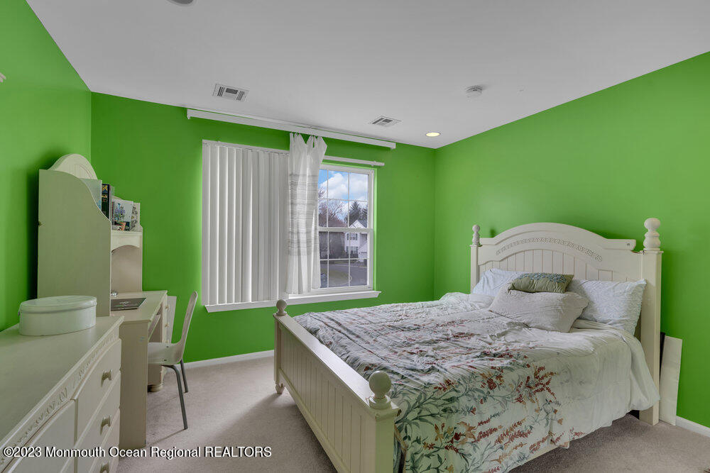 4 Blacksmith Pass Colts Neck, NJ 07722 - Photo 20 of 38 a bedroom with a bed and a flat tv screen on dresser