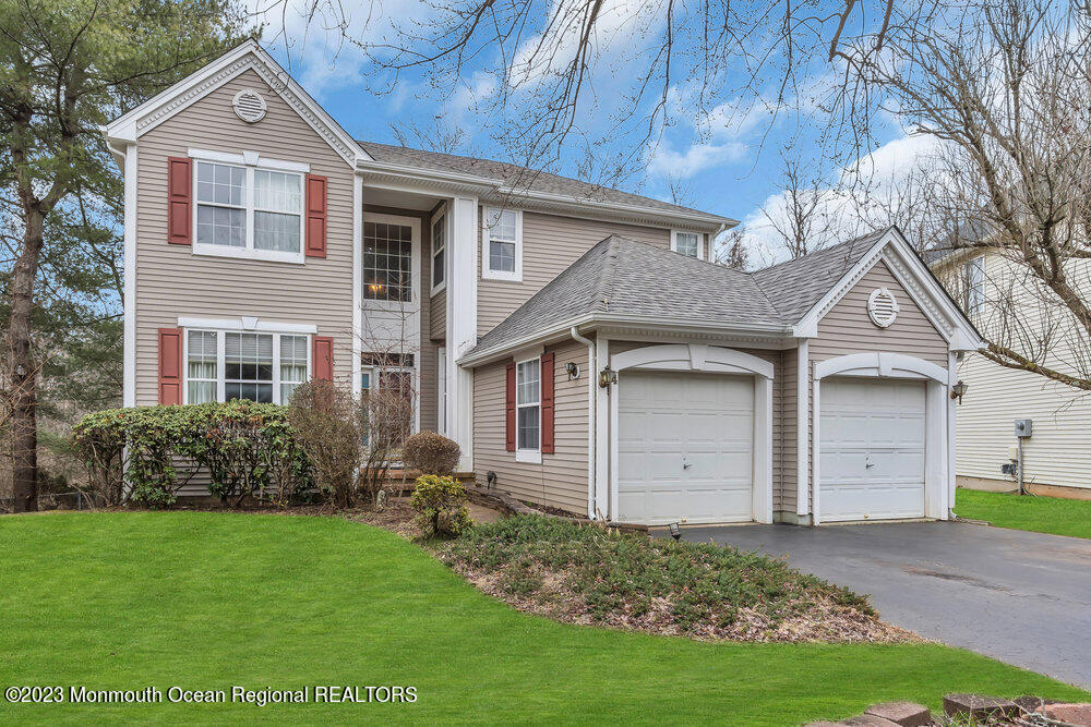 4 Blacksmith Pass Colts Neck, NJ 07722 - Photo 2 of 38 a front view of a house with a yard and garage