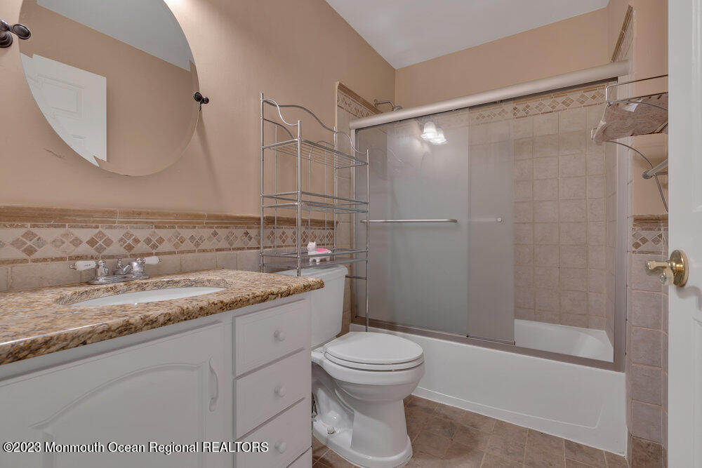 4 Blacksmith Pass Colts Neck, NJ 07722 - Photo 23 of 38 a bathroom with a granite countertop sink toilet and shower