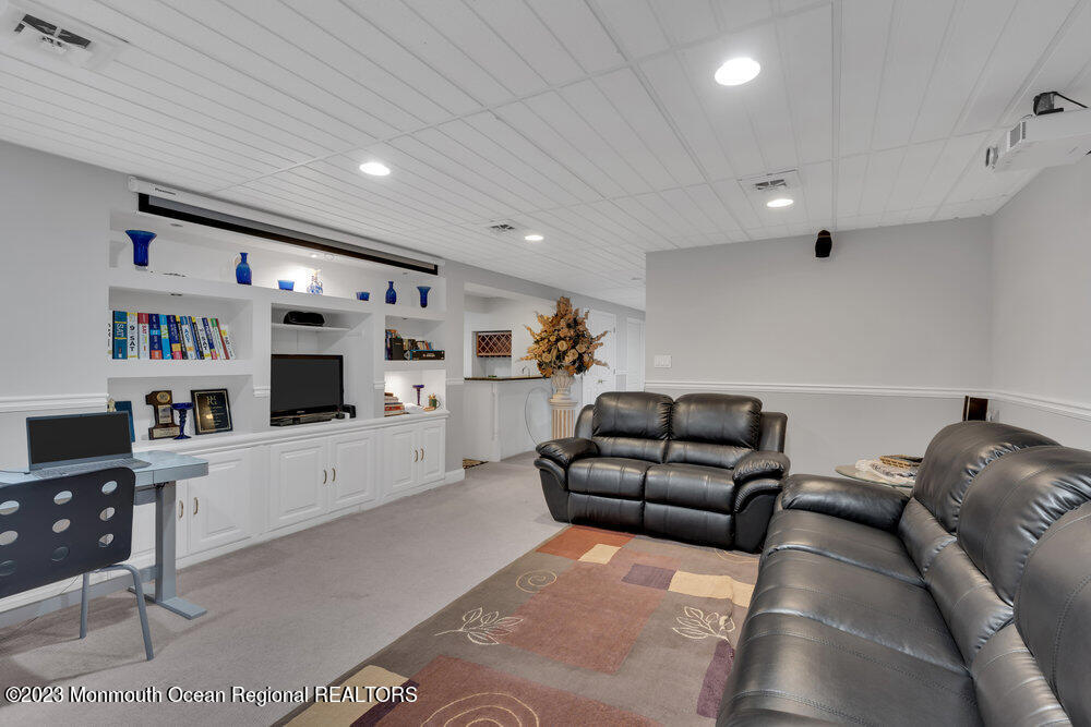 4 Blacksmith Pass Colts Neck, NJ 07722 - Photo 24 of 38 a living room with furniture and a flat screen tv