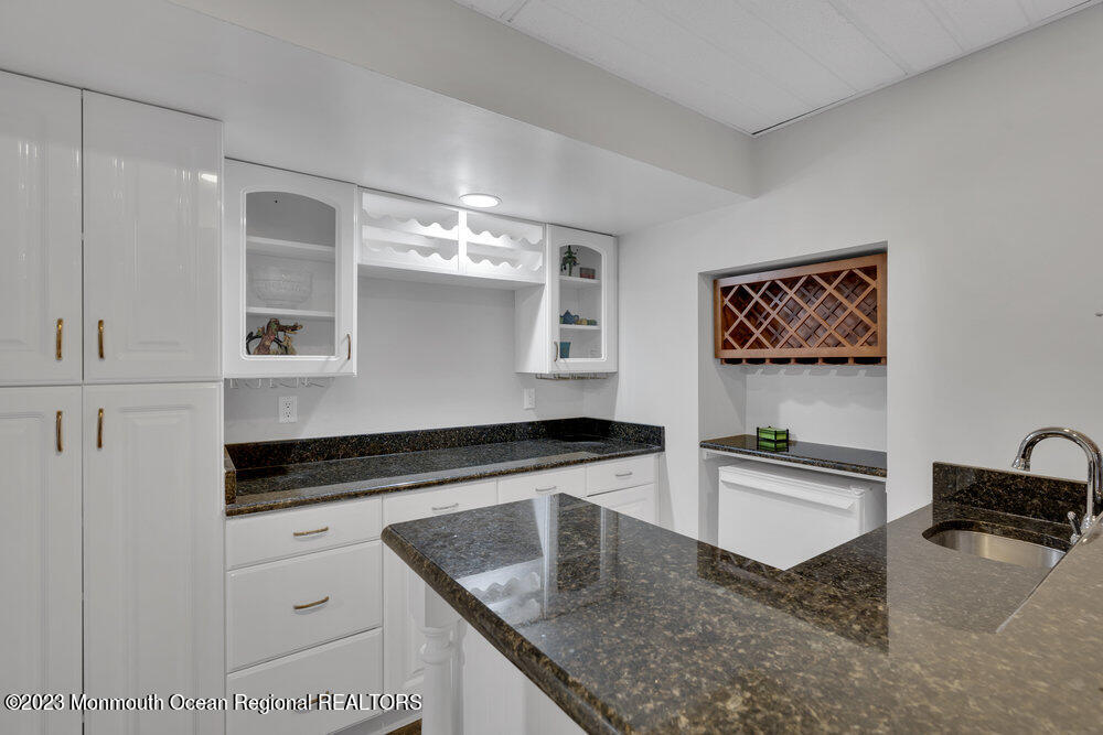 4 Blacksmith Pass Colts Neck, NJ 07722 - Photo 25 of 38 a kitchen with stainless steel appliances granite countertop a sink stove and refrigerator