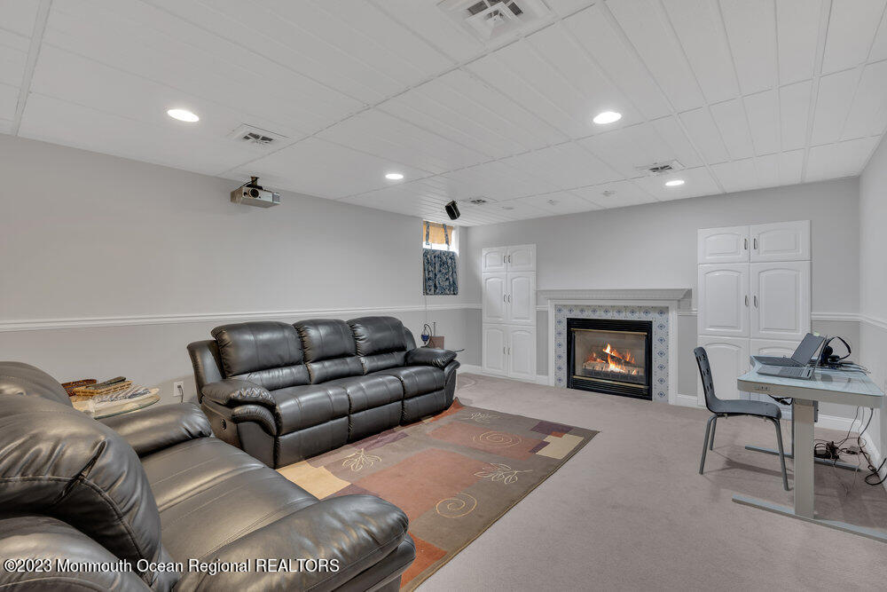 4 Blacksmith Pass Colts Neck, NJ 07722 - Photo 27 of 38 a living room with furniture and a fireplace