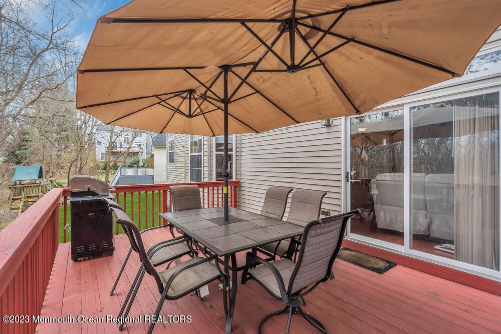 4 Blacksmith Pass Colts Neck, NJ 07722 - Photo 28 of 38 a view of a patio with a table and chairs under an umbrella