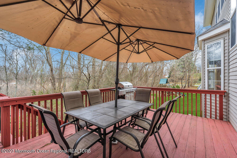 4 Blacksmith Pass Colts Neck, NJ 07722 - Photo 29 of 38 a view of balcony with furniture and wooden deck