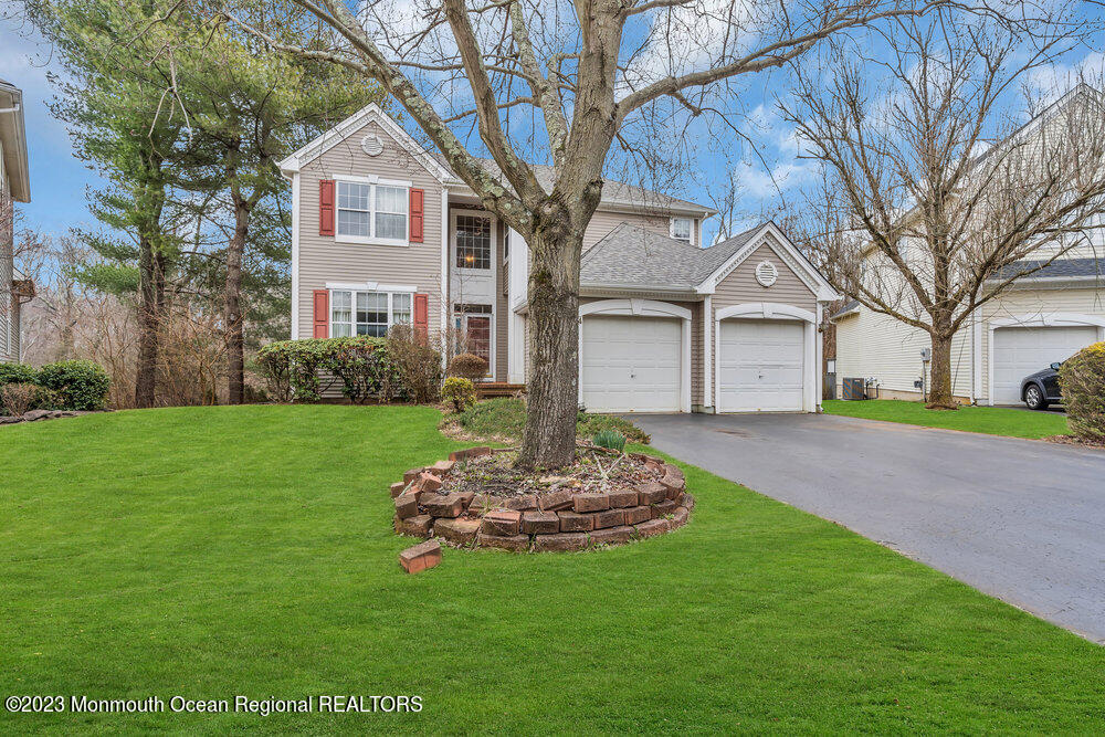 4 Blacksmith Pass Colts Neck, NJ 07722 - Photo 38 of 38 a front view of a house with a yard and garage