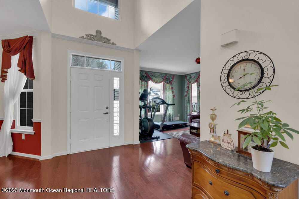 4 Blacksmith Pass Colts Neck, NJ 07722 - Photo 4 of 38 a living room with furniture a potted plant and a painting on the wall