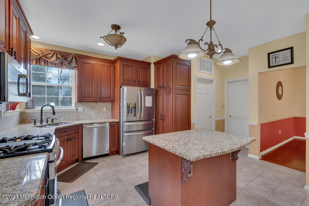 4 Blacksmith Pass Colts Neck, NJ 07722 - Photo 8 of 38 a kitchen with stainless steel appliances granite countertop a sink a stove and refrigerator