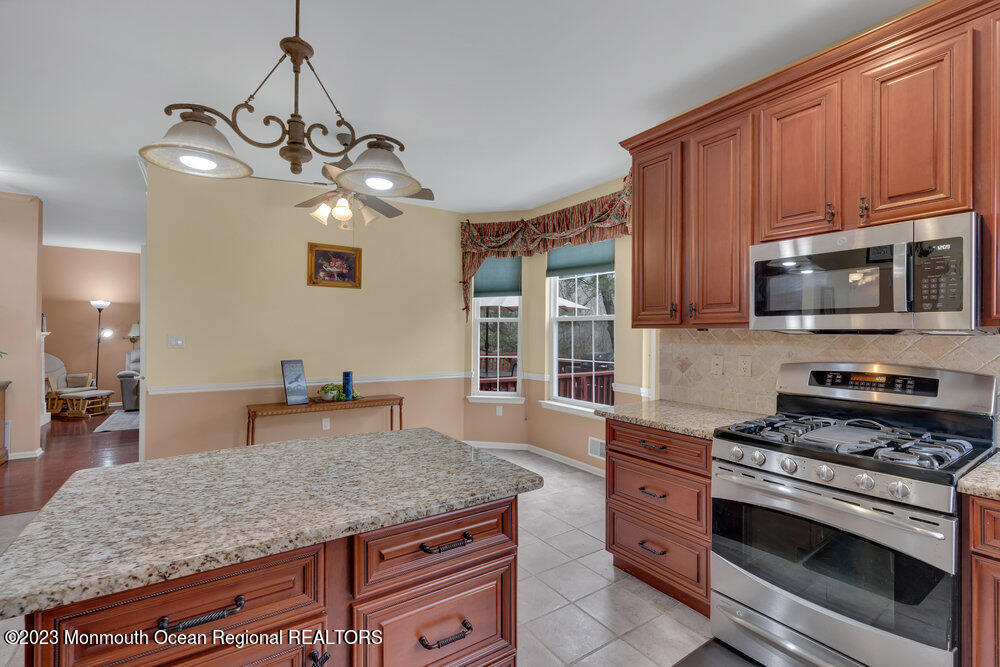 4 Blacksmith Pass Colts Neck, NJ 07722 - Photo 10 of 38 a kitchen with stainless steel appliances granite countertop a stove a oven a sink dishwasher and cabinets with wooden floor