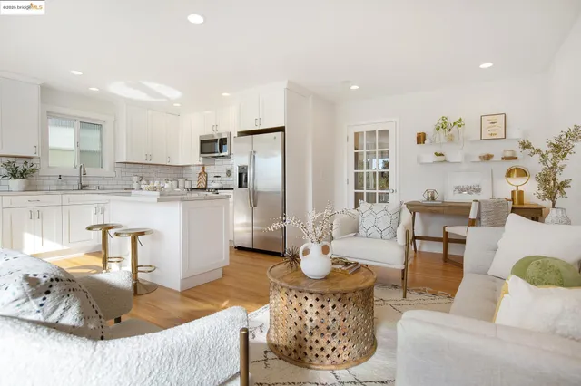 a living room with furniture and kitchen view