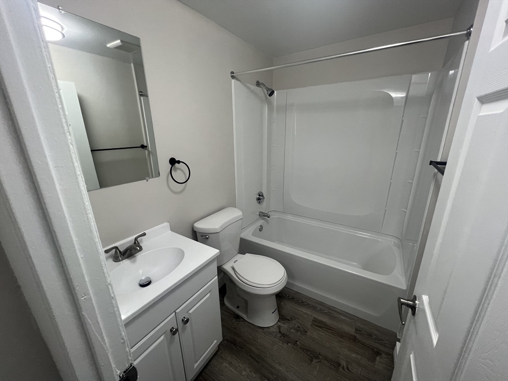 328 Greenwood Street, Unit A 1 Worcester, MA 01607 - Photo 6 of 9 a bathroom with a sink a toilet and shower a mirror