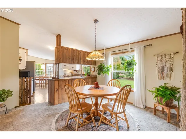 a view of a dining room with furniture and front door