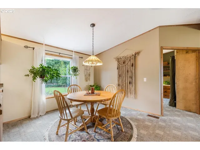 a view of a dining room with furniture window and outside view