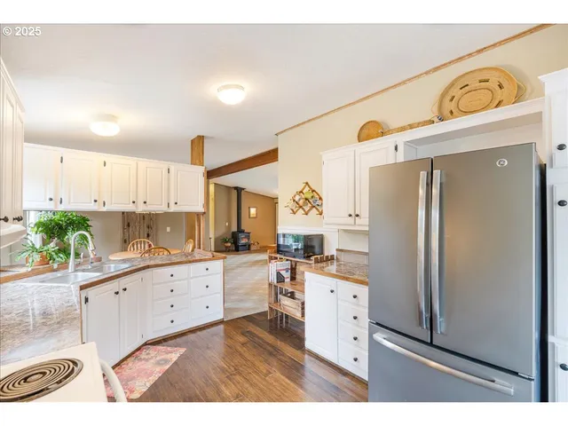 a kitchen with stainless steel appliances granite countertop a refrigerator and a stove top oven