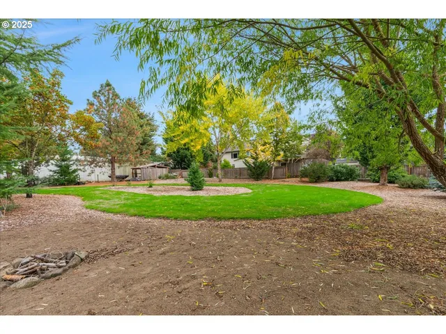 a green field with trees in the background
