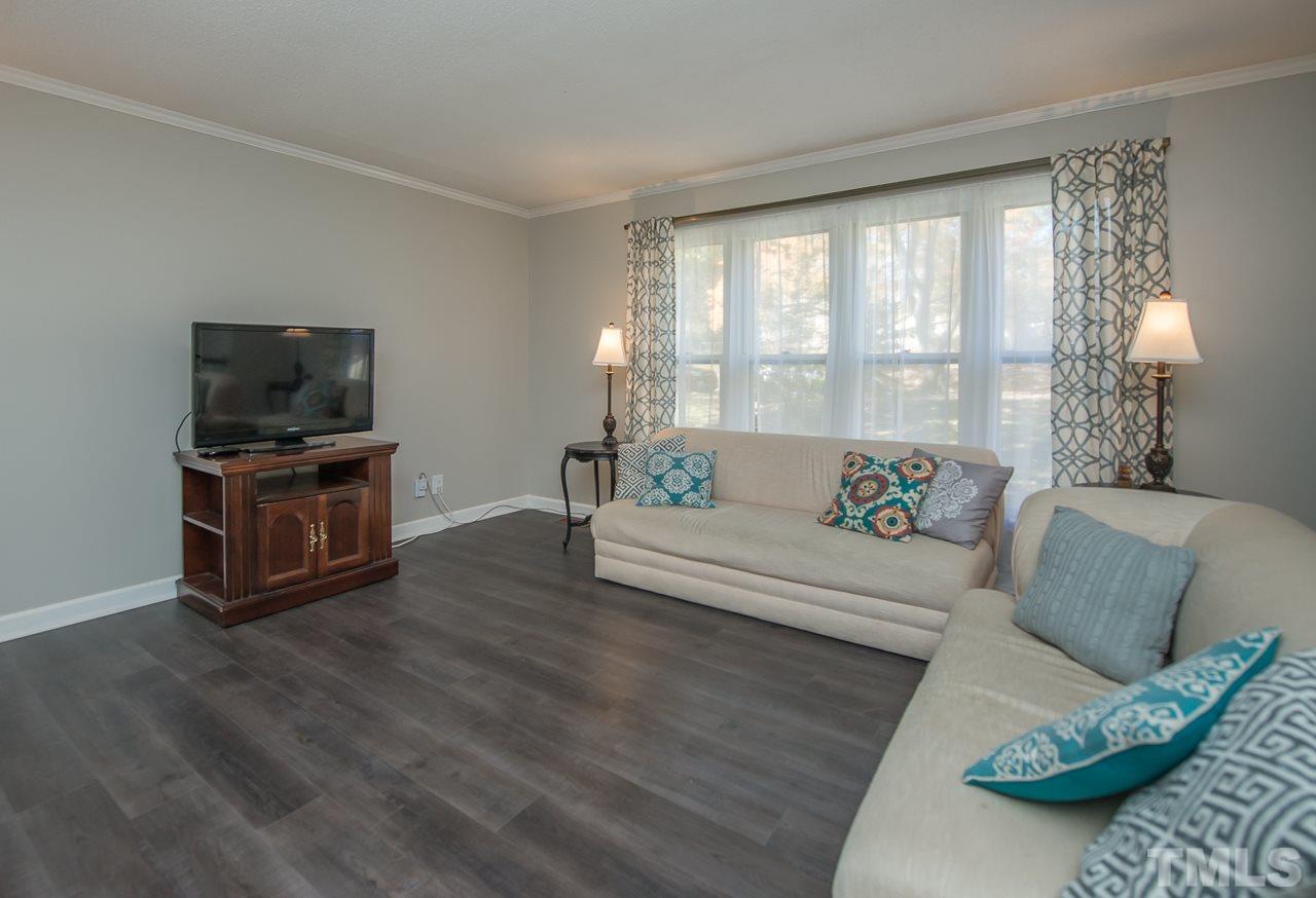 1924 Quail Ridge Road Raleigh, NC 27609 - Photo 3 of 25 a living room with furniture and a flat screen tv