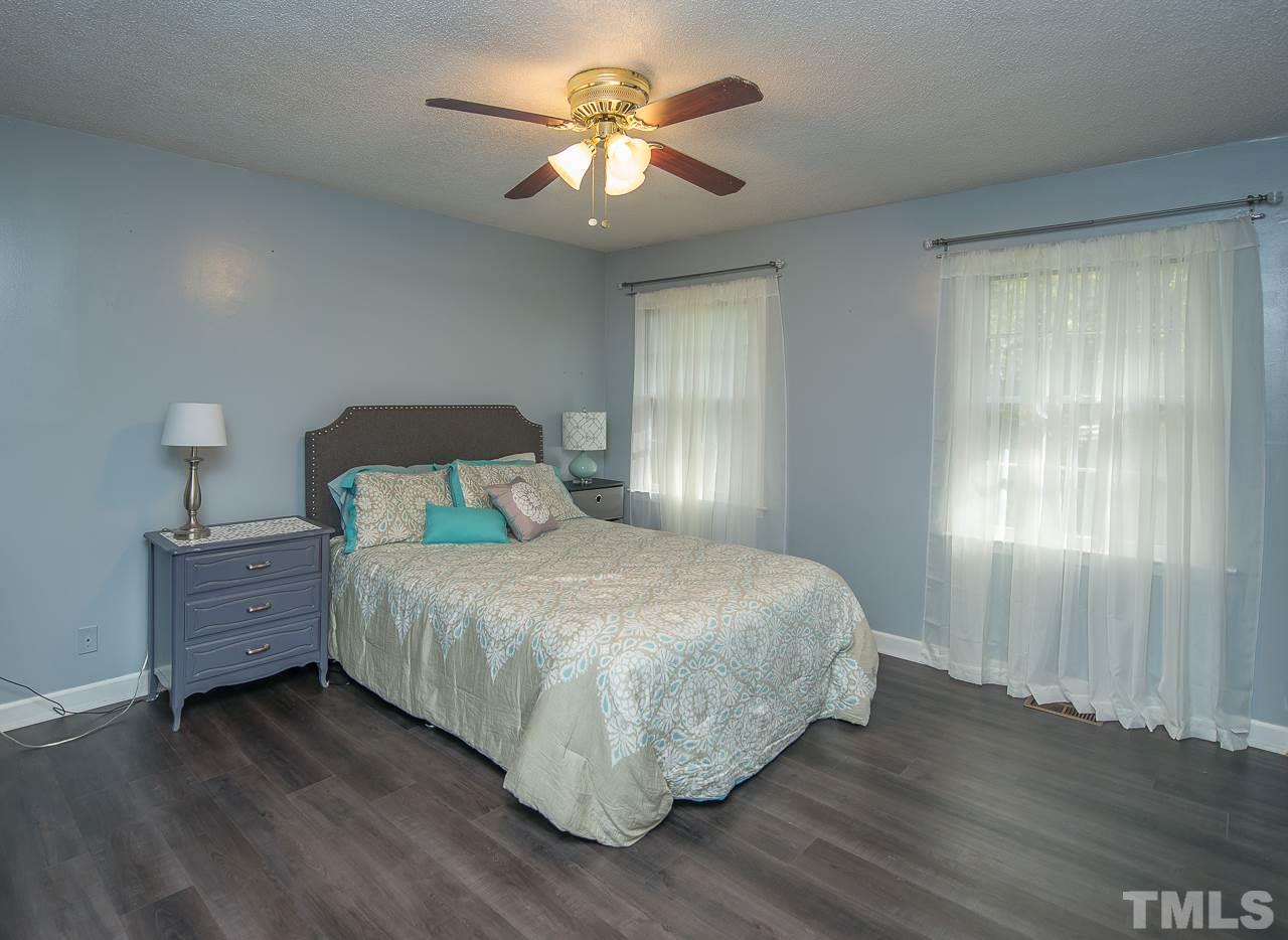 1924 Quail Ridge Road Raleigh, NC 27609 - Photo 8 of 25 a bedroom with a bed and a chandelier
