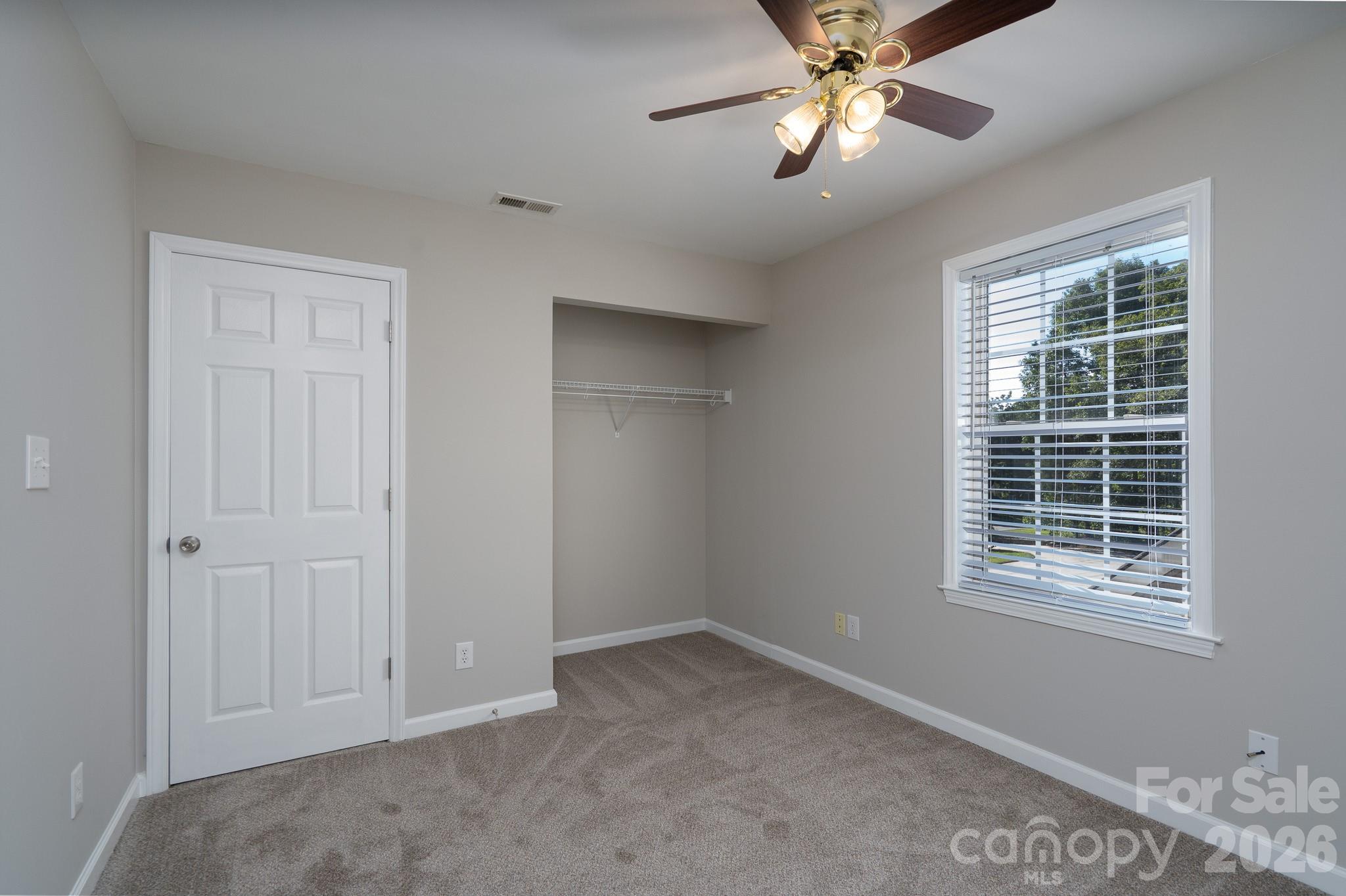 5356 Zion Church Road Concord, NC 28025 - Photo 23 of 46 a view of an empty room with window and chandelier fan