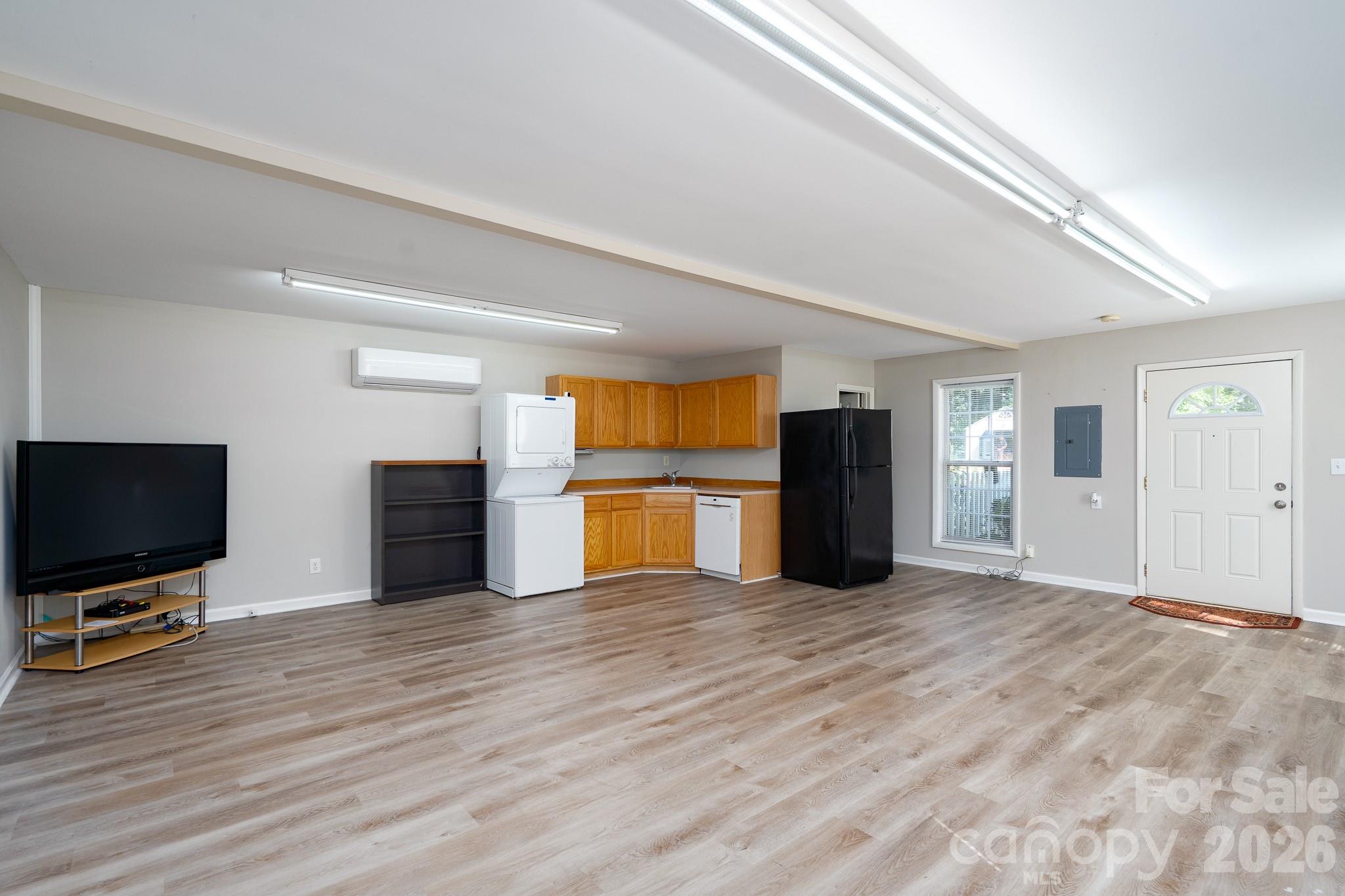 5356 Zion Church Road Concord, NC 28025 - Photo 38 of 46 a view of a kitchen with a sink and a flat screen tv