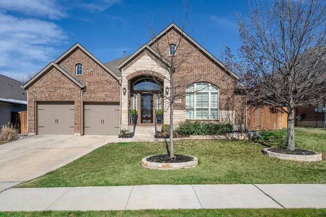 a front view of a house with a yard
