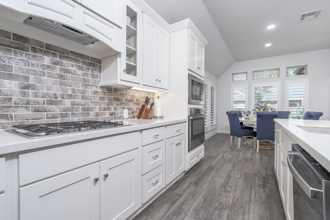 1232 Lakeside Ranch Road Georgetown, TX 78633 - Photo 17 of 31 a kitchen with cabinets wooden floor and a sink