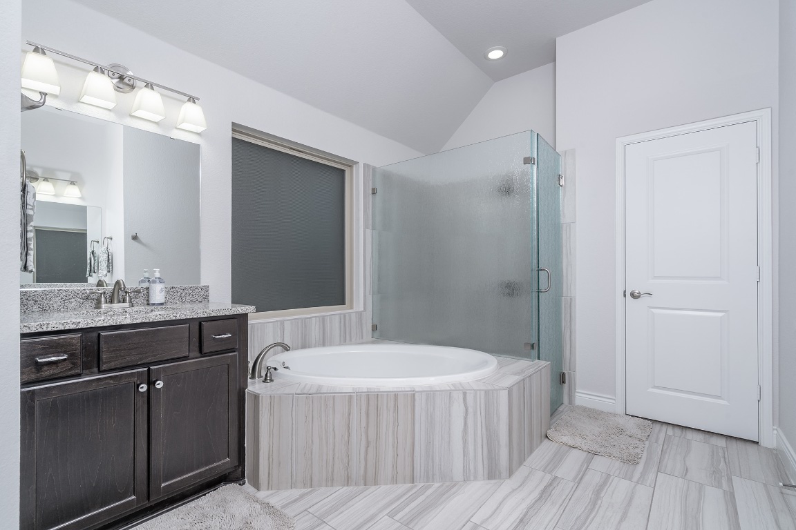 1232 Lakeside Ranch Road Georgetown, TX 78633 - Photo 21 of 31 a bathroom with a tub sink and mirror