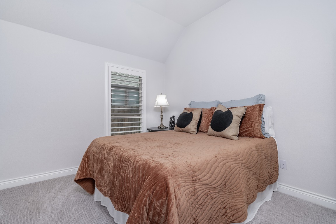 1232 Lakeside Ranch Road Georgetown, TX 78633 - Photo 25 of 31 a bed sitting in a bedroom next to a small window