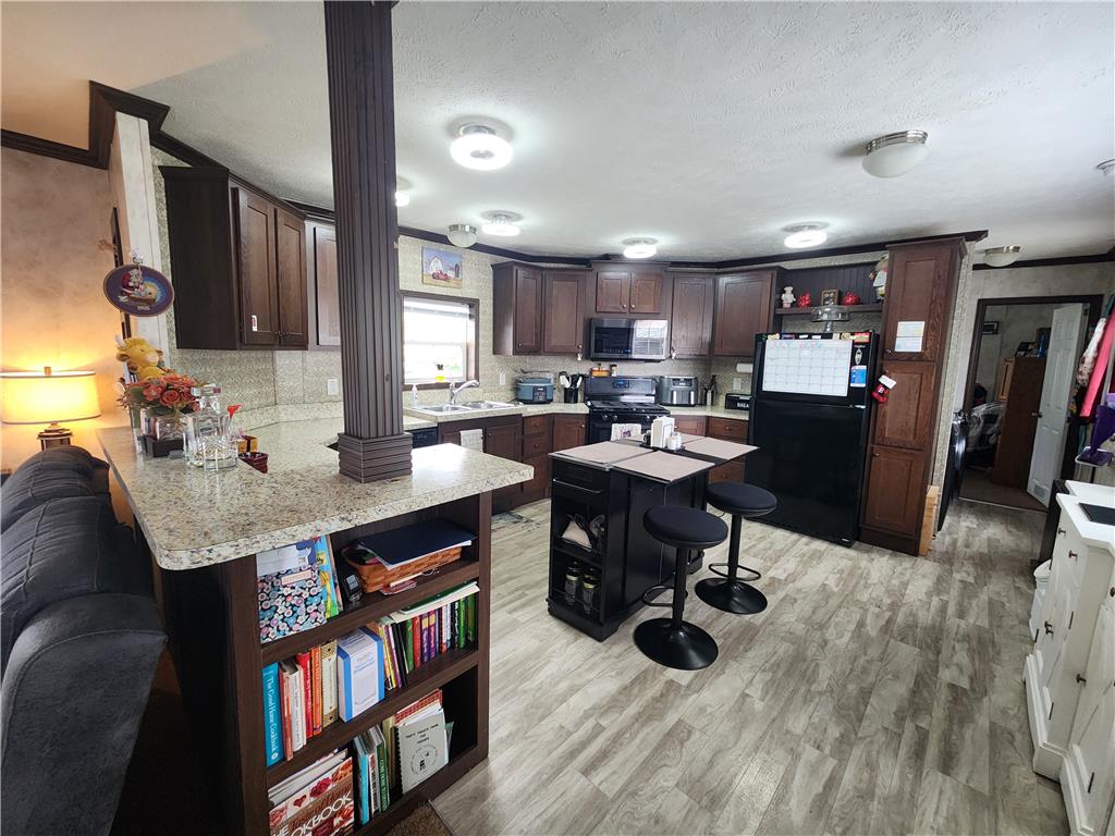 49 Ritz Craft Street Walnutport, PA 18088 - Photo 4 of 11 A well-appointed kitchen features dark wood cabinetry and modern appliances.