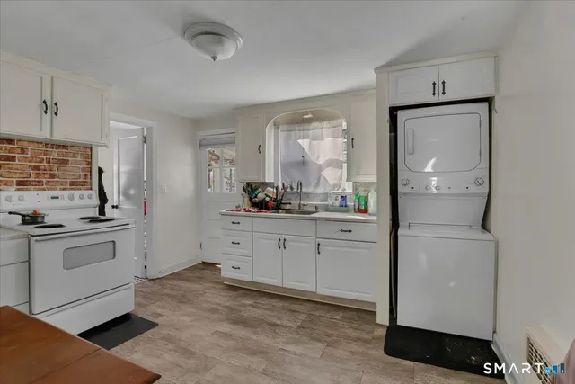 a room with white cabinets and appliances