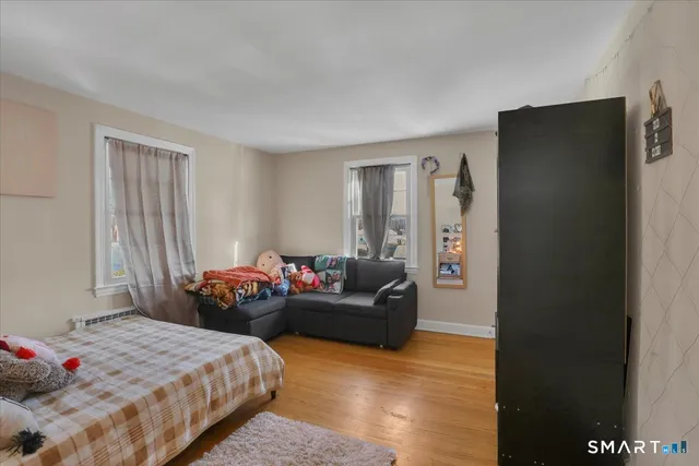 a bedroom with a bed and a potted plant