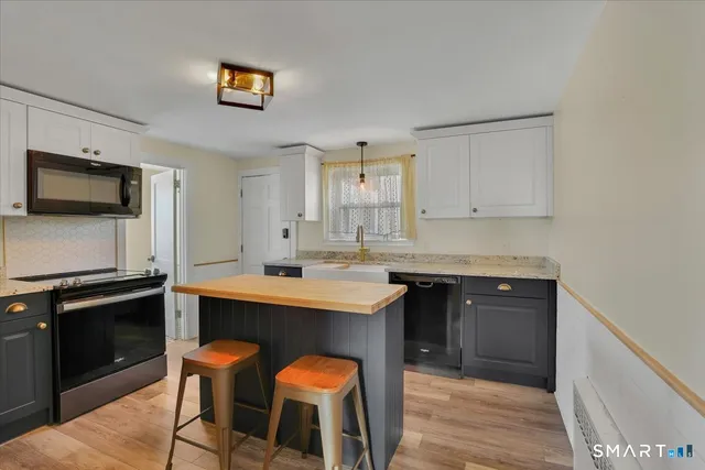 a kitchen with a sink cabinets and stainless steel appliances