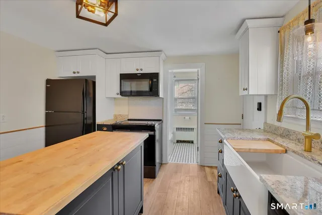 a kitchen with a refrigerator sink and stove