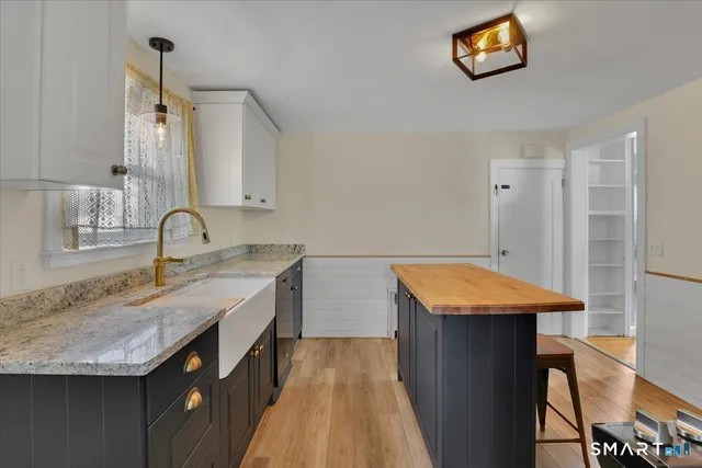 a kitchen with a sink and a refrigerator