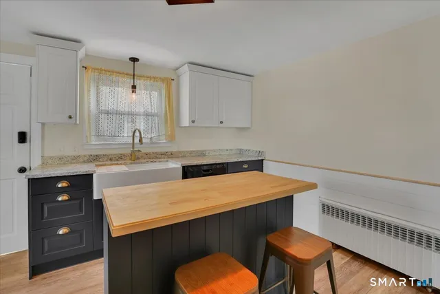 a kitchen that has a sink and a stove in it
