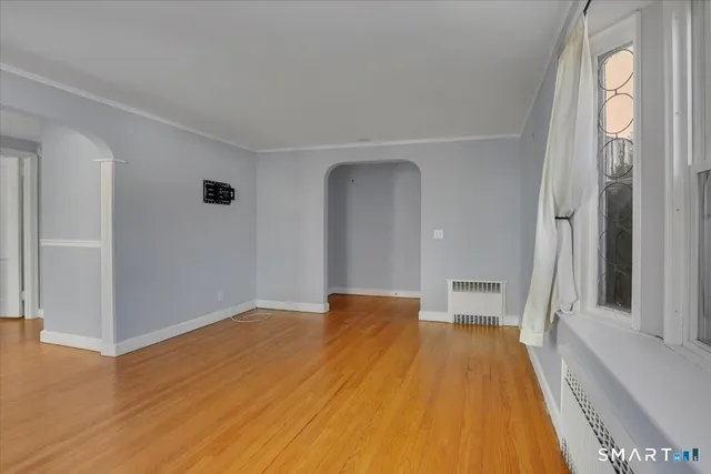 wooden floor in an empty room with a window